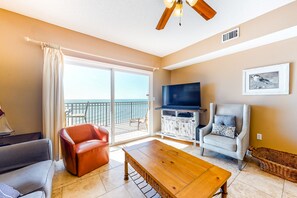 Relax in this stylish living room with a sliding glass door leading to a balcony and a comfortable seating area.