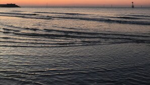 A calm sea at sunset with a distant pier and a small island. - Cocoon Design - Comfortable and bright - Beachfront & Golden Triangle (Deauville)