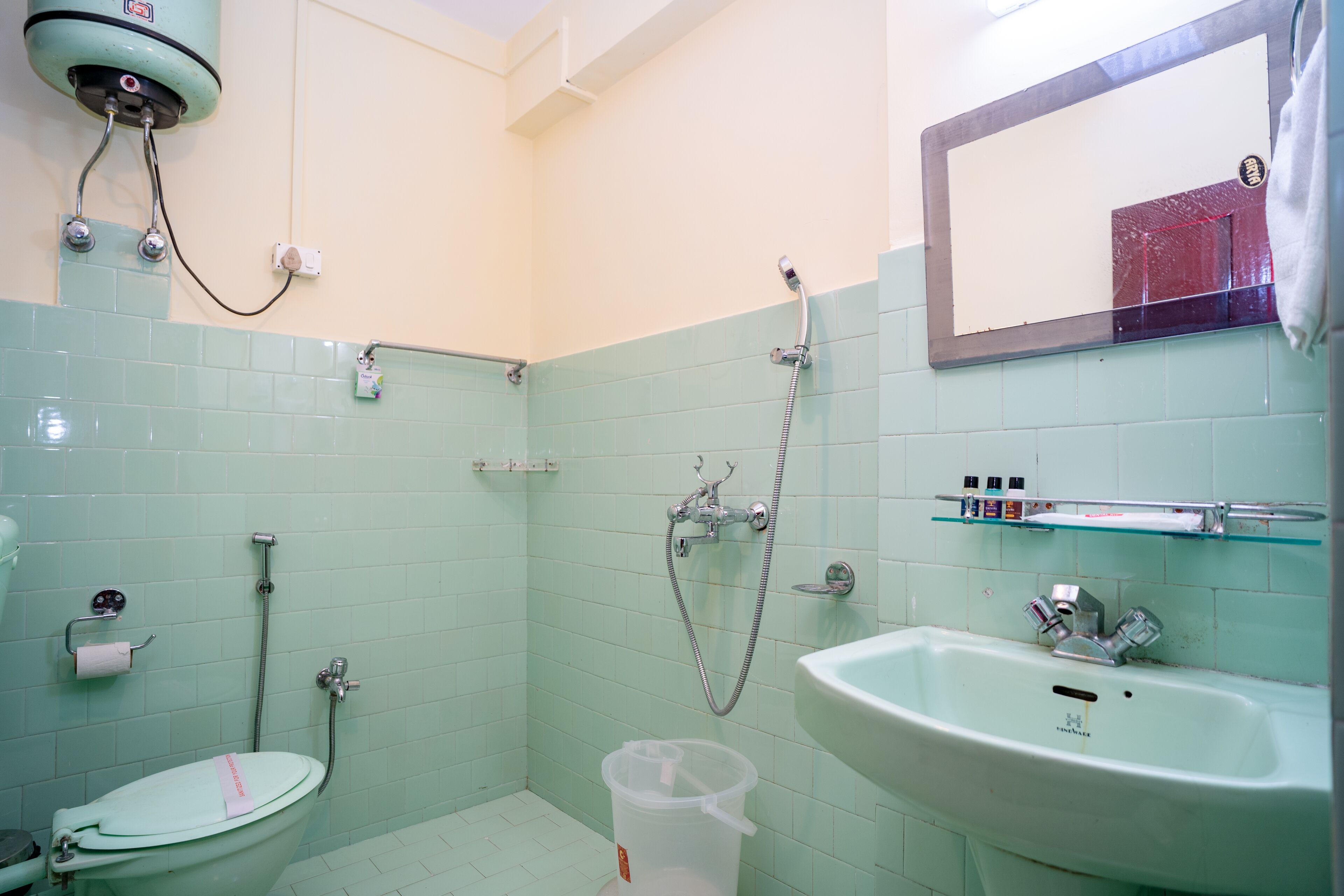 A bathroom with a toilet, sink, and shower.