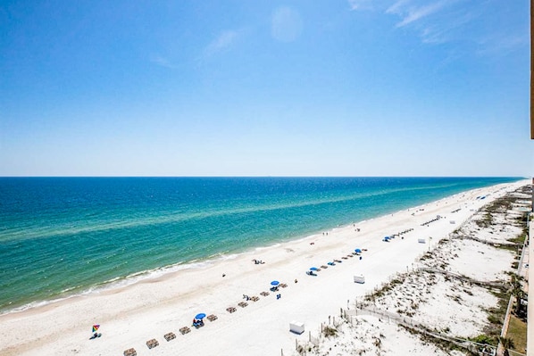 Relax on the pristine beach with rows of comfortable sun loungers and umbrellas.