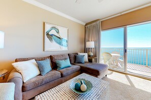 Relax in a spacious living area with a sofa set, coffee table, and ocean views from the balcony.