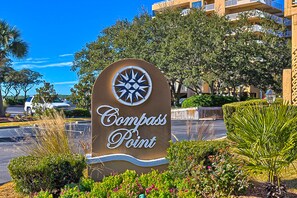 Welcome to Compass Point, where lush landscaping and a scenic view of the surrounding buildings await.