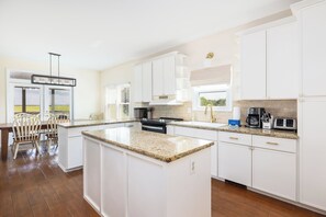 Fridge, dishwasher, coffee/tea maker, cookware/dishes/utensils