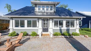 A two-story house with a front porch, a garage, and a driveway. - The Vintage Lake House w/ Private Dock (Russells Point)