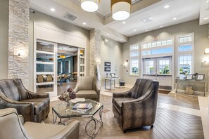 Relax in style with comfortable seating and a spacious layout, featuring a reception desk and multiple seating areas.