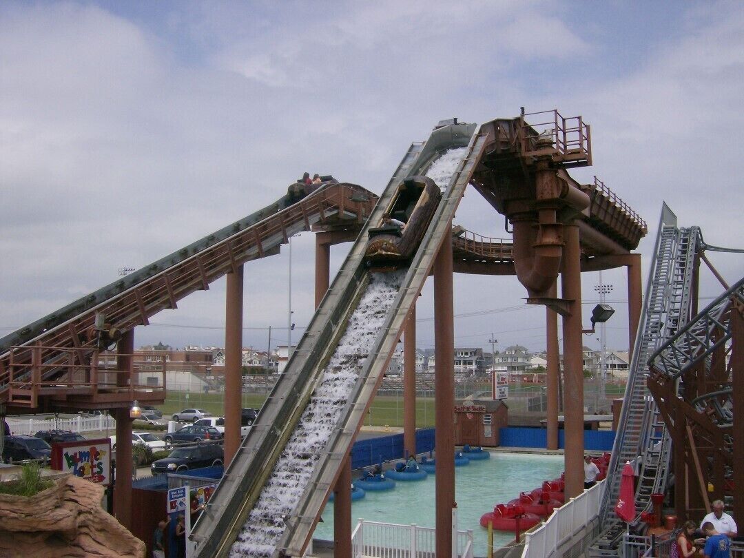 A water park with multiple water slides and a pool area.