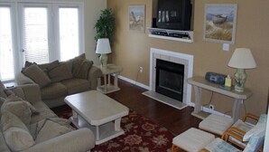 A living room with a fireplace, a television, and a sofa.