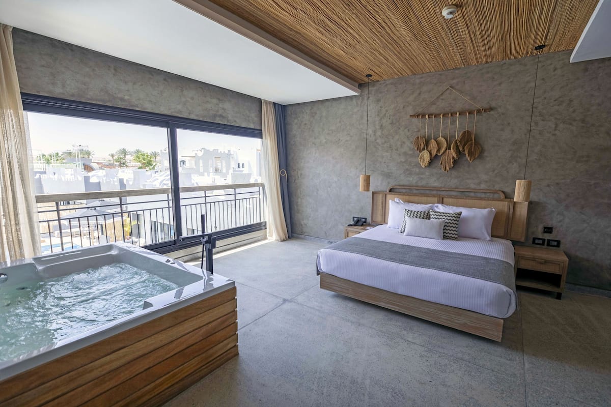 Executive Suite | 1 bedroom, free minibar items, in-room safe, individually decorated
