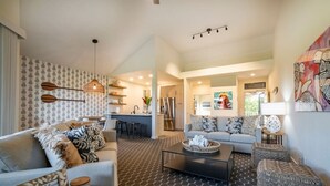 A modern living room with a sofa, coffee table, and patterned rug.