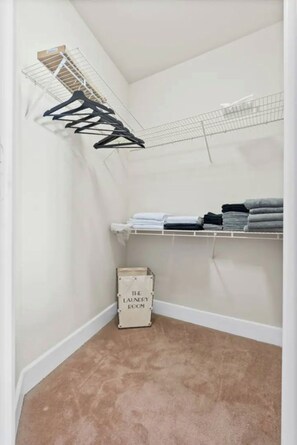 Convenient laundry facilities with a drying rack and storage.