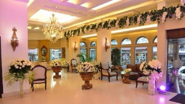 A spacious lobby with chandeliers, floral arrangements, and comfortable seating. - Royal Garden Hotel Beirut (Beirut)