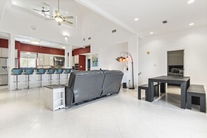 Enjoy meals in the dining area with a large table and benches, or relax in the seating area with a sofa and side table.