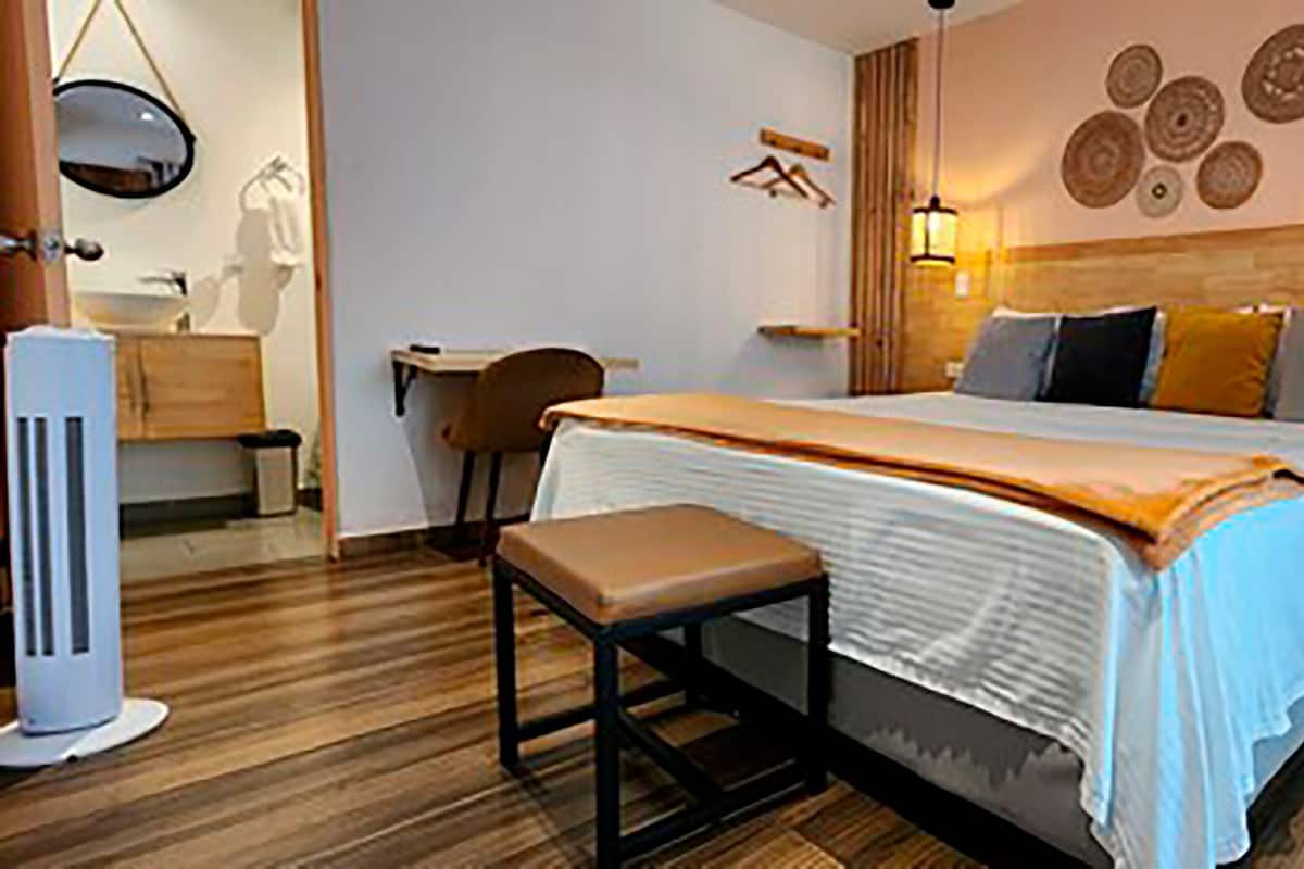 Premium bedding, desk, laptop workspace, blackout drapes