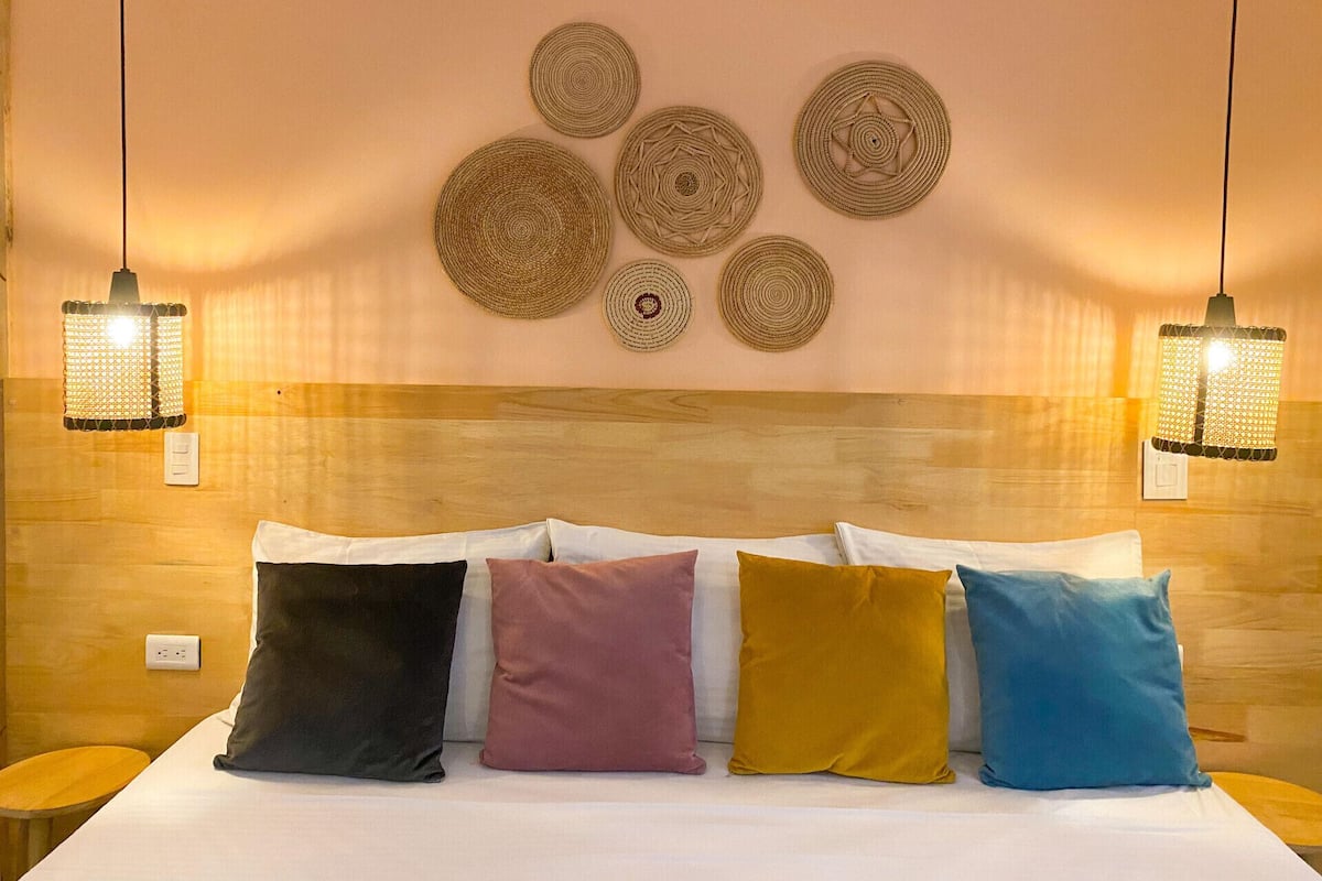 Premium bedding, desk, laptop workspace, blackout drapes
