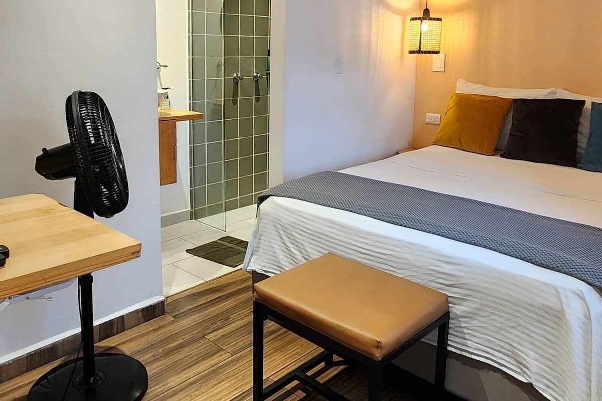 Premium bedding, desk, laptop workspace, blackout drapes