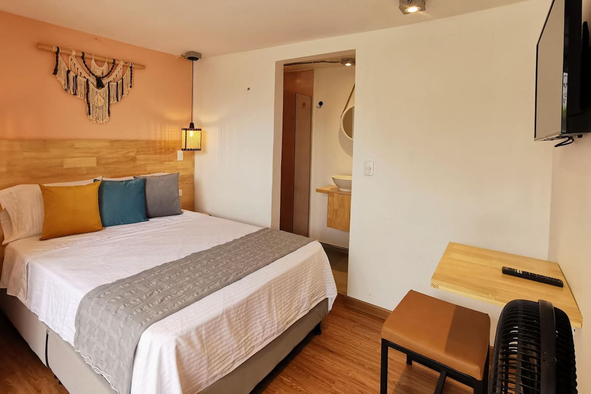 Premium bedding, desk, laptop workspace, blackout drapes
