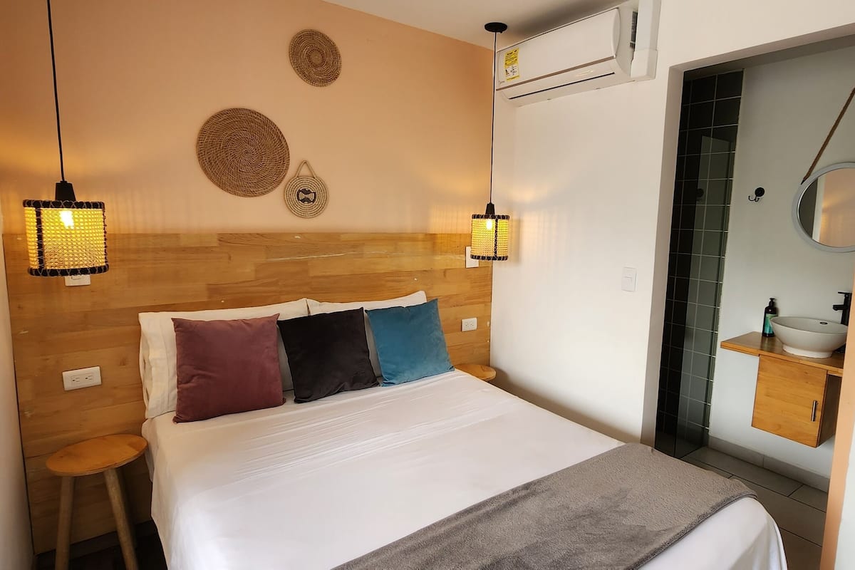 Premium bedding, desk, laptop workspace, blackout drapes