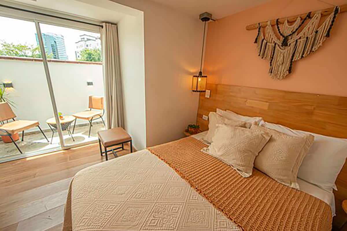 Premium bedding, desk, laptop workspace, blackout drapes