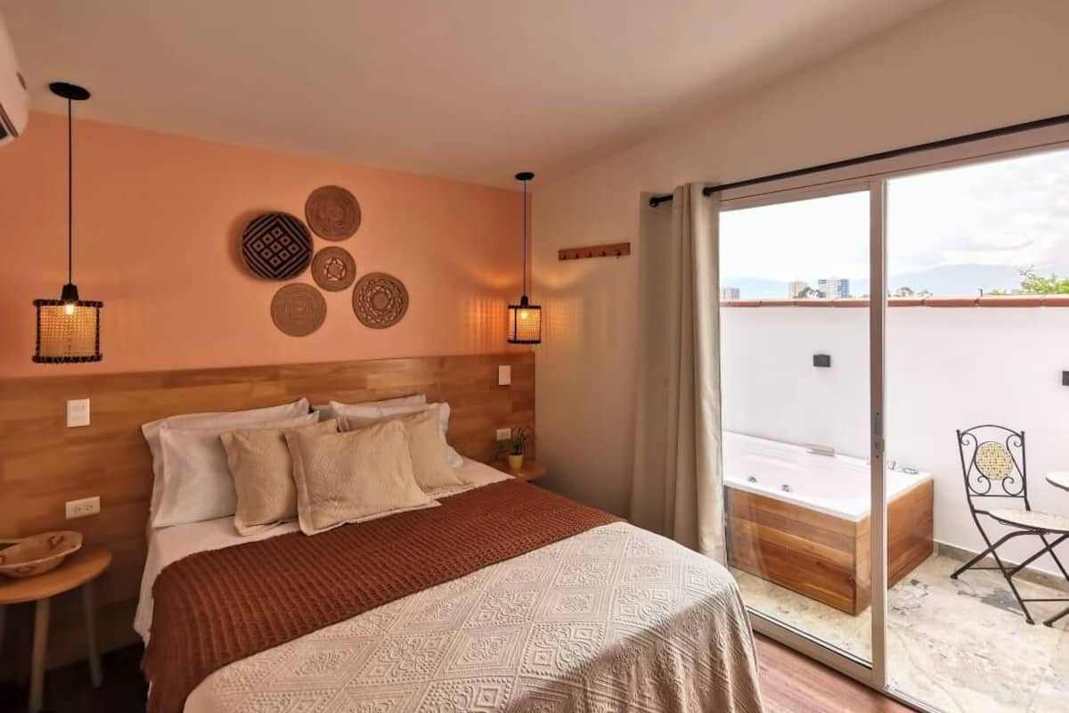 Premium bedding, desk, laptop workspace, blackout drapes