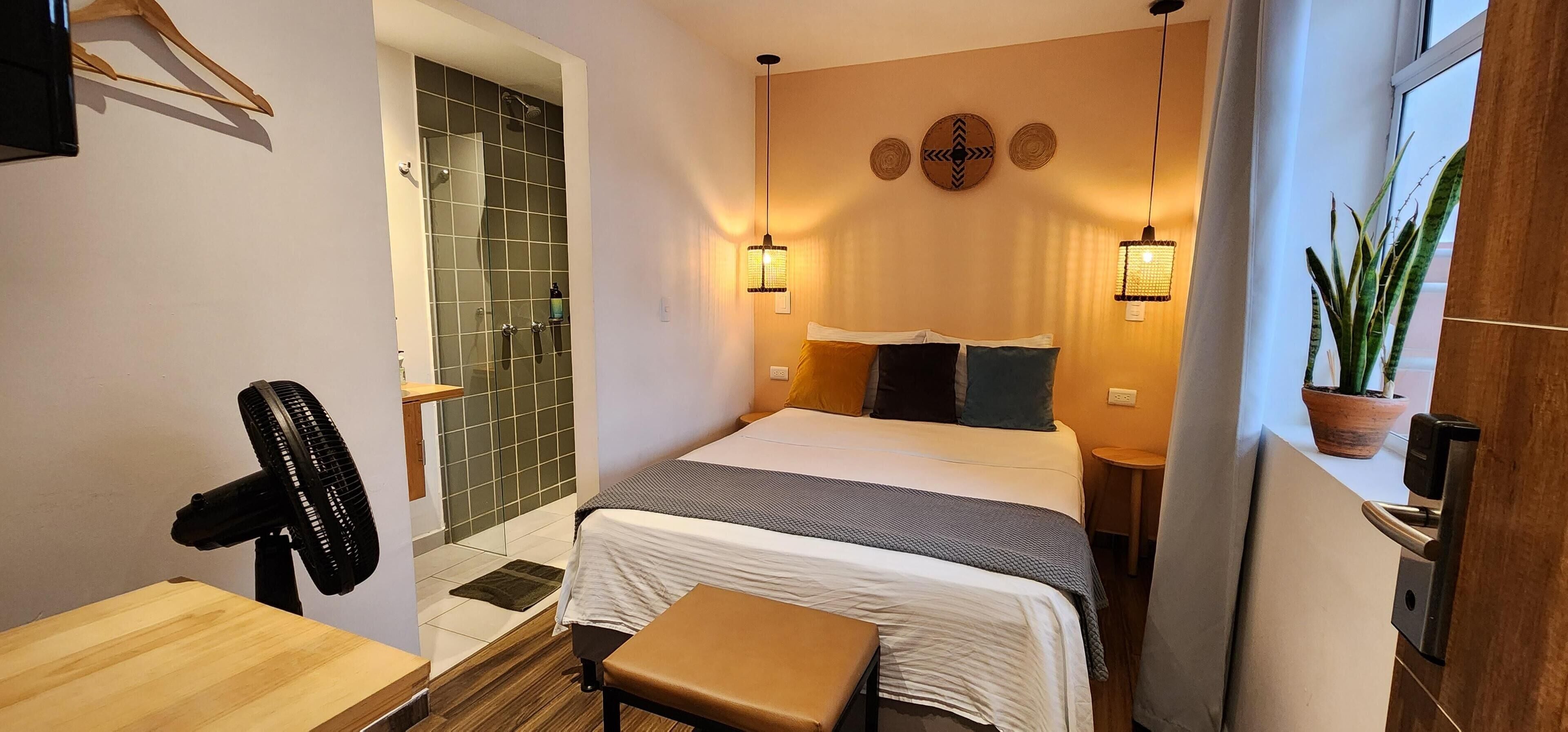 Premium bedding, desk, laptop workspace, blackout drapes