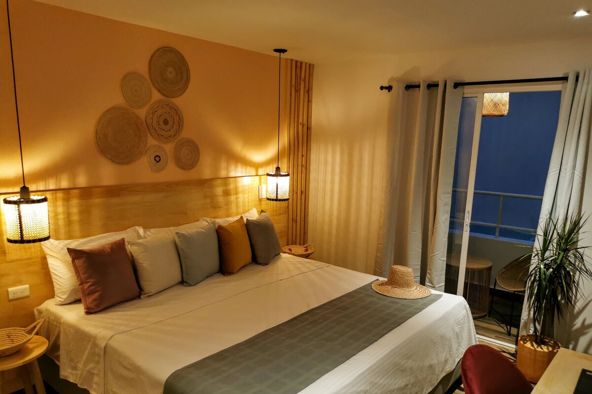 Premium bedding, desk, laptop workspace, blackout drapes