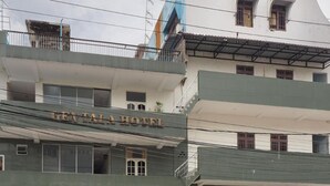 A hotel with a sign reading "GENTA LA HOTEL" and a visible entrance with a motorcycle parked outside. - New Hotel Gentala (Medan)