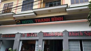 A hotel named "HOTEL THANH BINH" with multiple storefronts and balconies. - Thanh Binh Hotel Pleiku (Dien Hong)