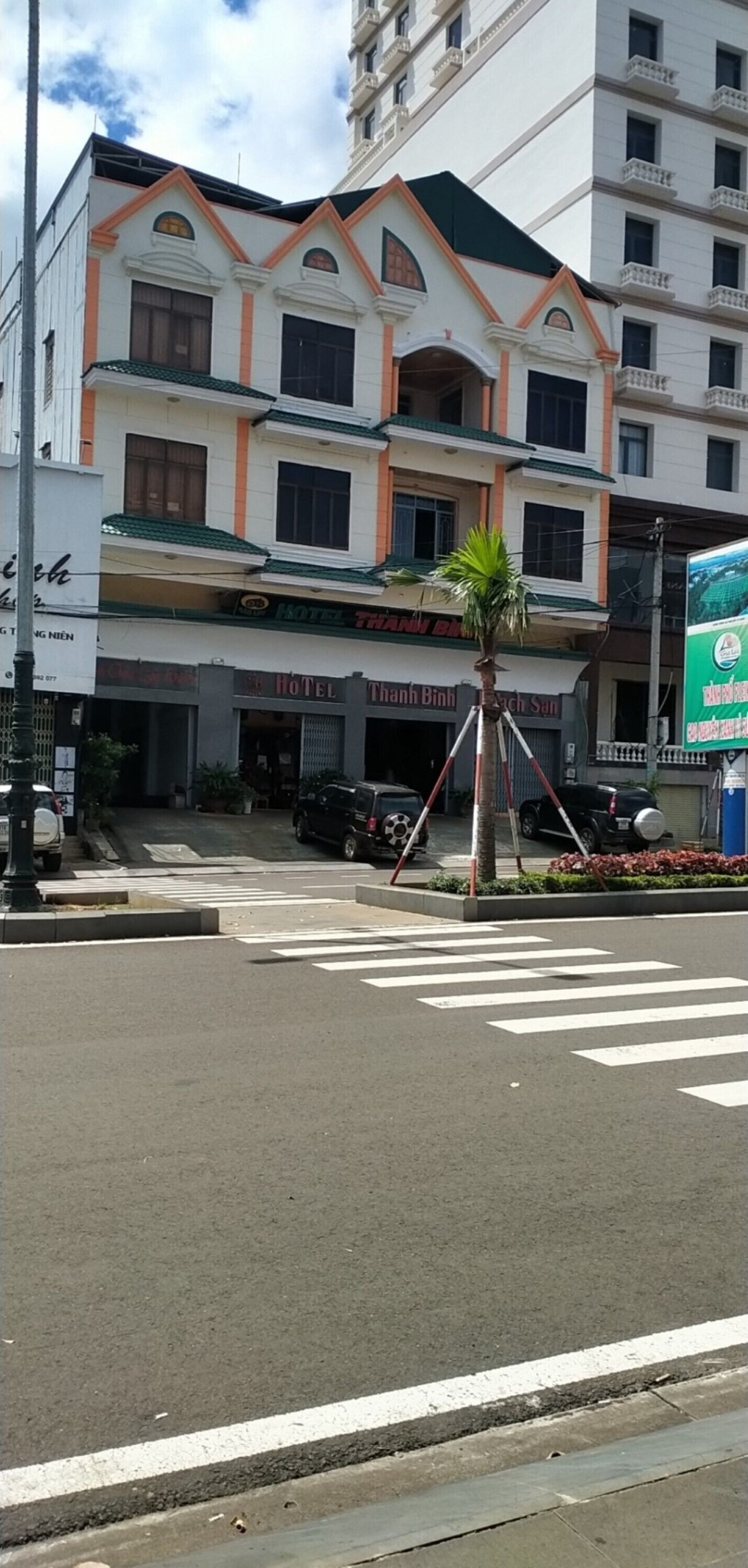 A hotel with a traditional architectural style, featuring a prominent entrance and multiple windows.
