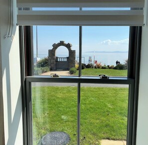 Enjoy a serene view of the well-maintained lawn from the room's large windows.
