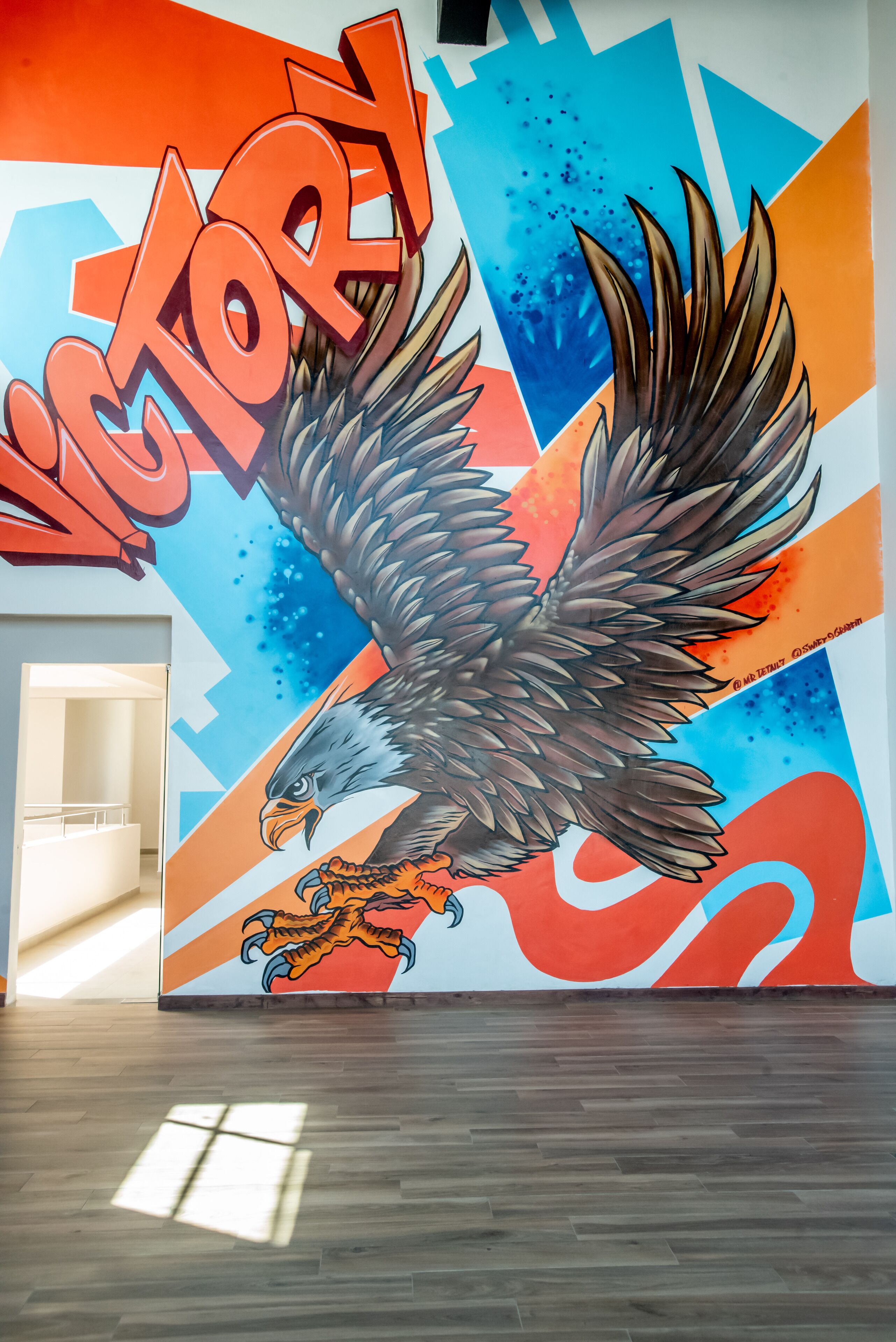 A mural with an eagle and the word 'VICTORY' on a wall.