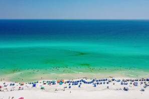 A beach with clear turquoise water, white sand, and numerous umbrellas. - Cabana Crush | Private Pool | 6-Seater Golf Cart | 5 Mins to Beach (Miramar Beach)