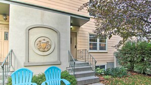 A building with a large emblem on the wall, a set of stairs leading to the entrance, and two blue chairs in front. - Mid-Century Bozeman Townhome ~ 1 Mi to Dtwn! (Bozeman)