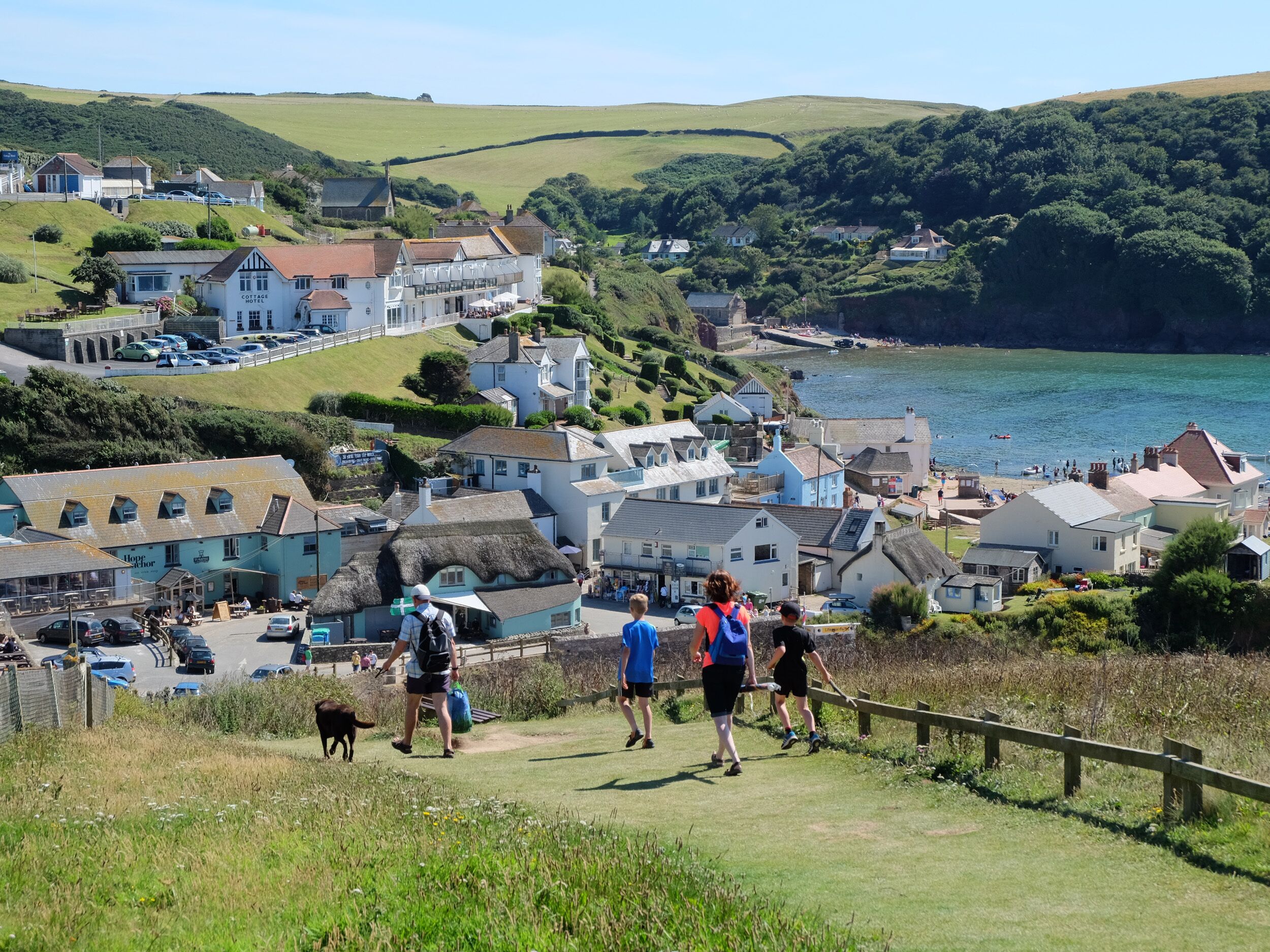 A coastal town with a variety of buildings, including a hotel with a visible sign.