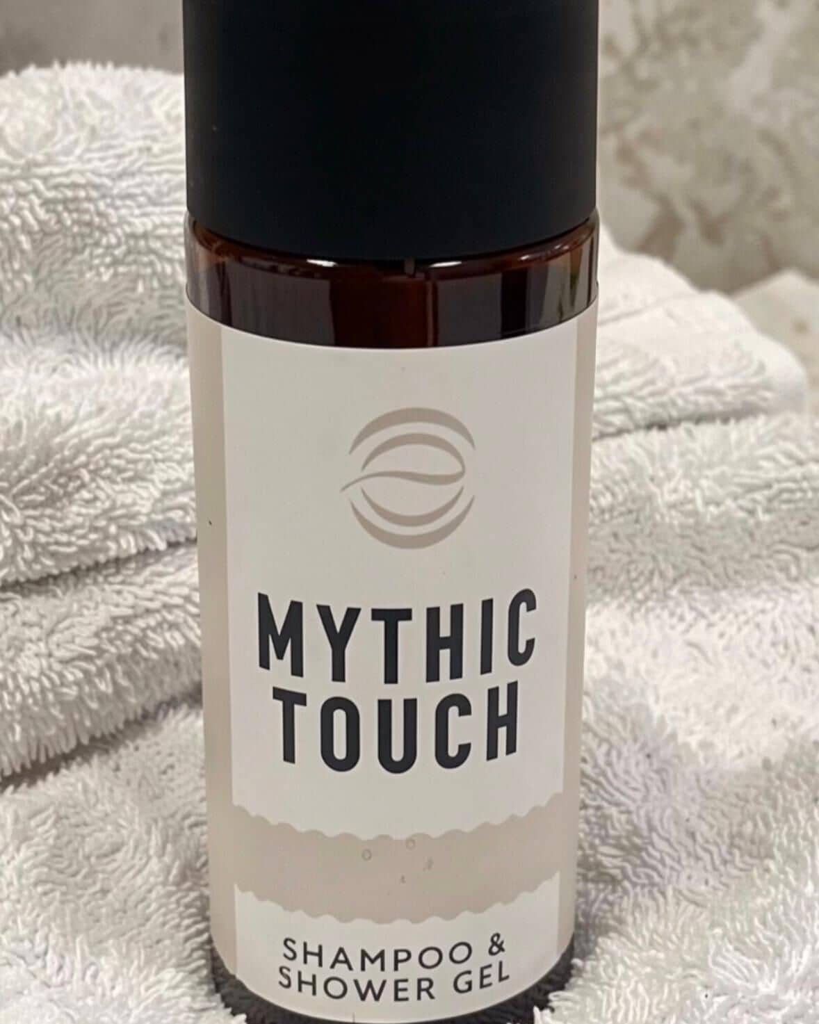 A bottle of 'Mythic Touch' shampoo and shower gel.