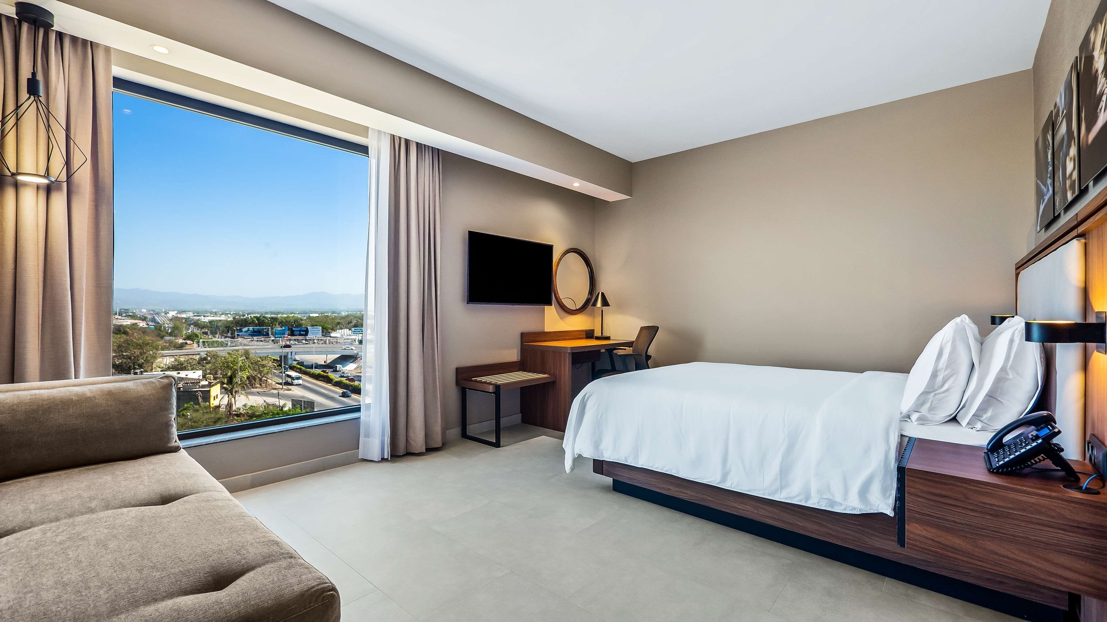 suite, 1 queen bed, non smoking | minibar, in-room safe, desk, blackout curtains