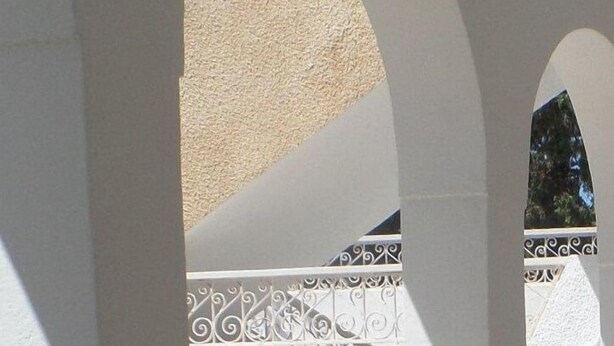 A covered outdoor area with white columns and a balustrade. - Vacation home in hammamet (Hammamet)