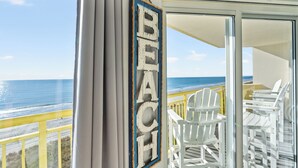 A balcony with white chairs and a view of the ocean. - Bay Watch 605-3BR/2BA Oceanfront Condo in North Myrtle Beach (North Myrtle Beach)
