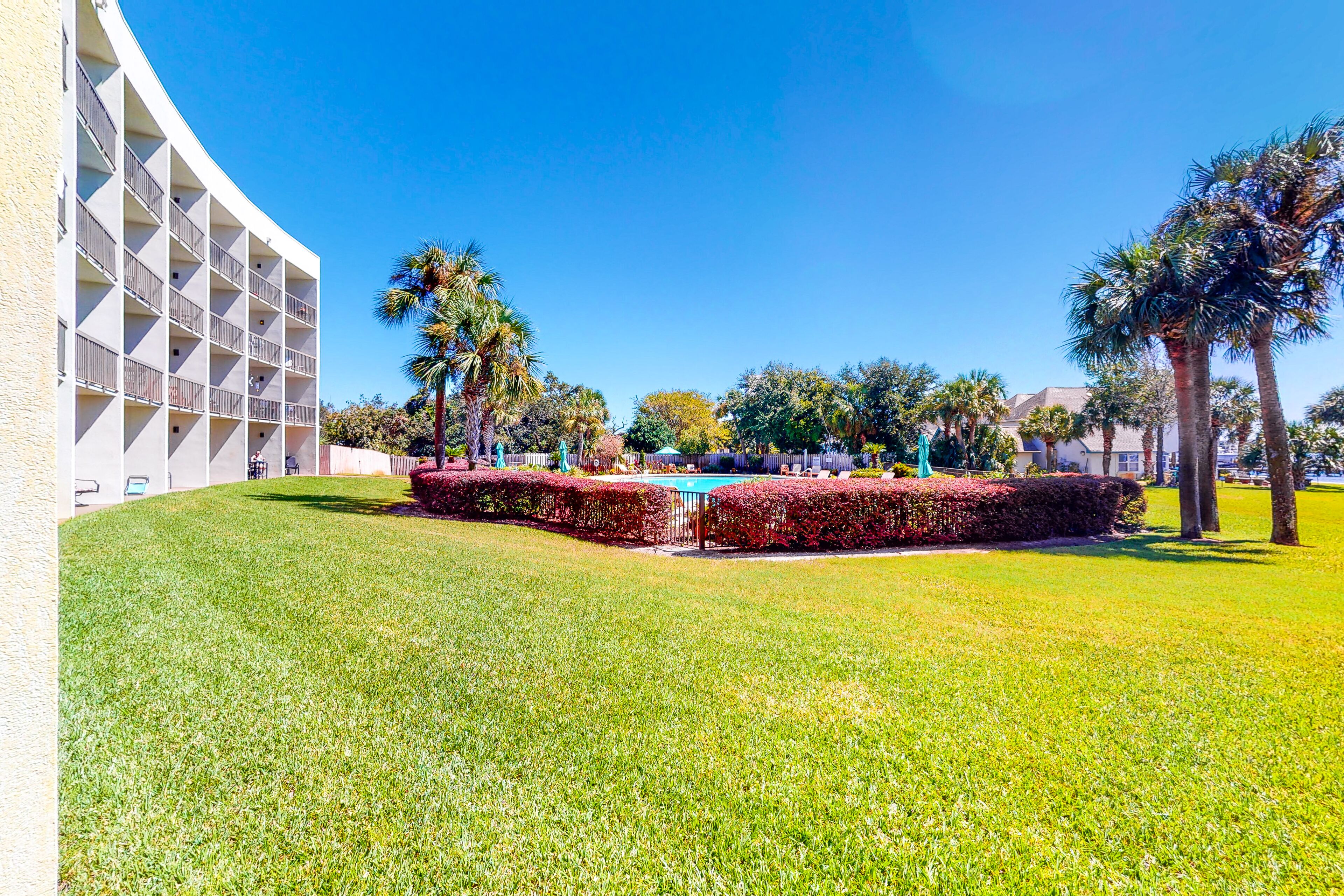 Bayfront studio with furnished patio, pool & water view