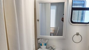 A compact bathroom with a pedestal sink, a toilet, and a small window. - Aqua Lodge Houseboat "Sea Turtle" (Tavernier)
