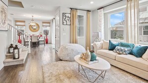 A spacious living room with a beige sofa, a round coffee table, and a staircase leading to another level. - A diamond in the rough (Rocklin)