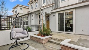 A modern townhouse with a patio, a hanging chair, and a small garden. - A diamond in the rough (Rocklin)