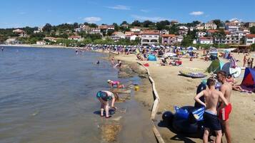 Guests can enjoy swimming, sunbathing, and beach activities on the sandy shore.