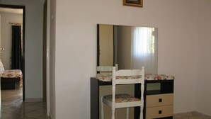 A bedroom with a bed, a dresser, a chair, and a mirror. - Apartment in Lopar with Seaview, Loggia, Air condition, WIFI (4229-6) (Lopar)