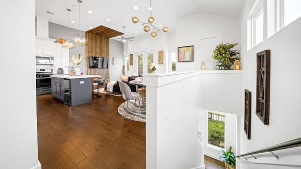 A spacious kitchen with modern appliances, a dining area with a round table, and a staircase leading to an upper level. - Spacious 3BR Houston Escape near Downtown with Spa (Houston)