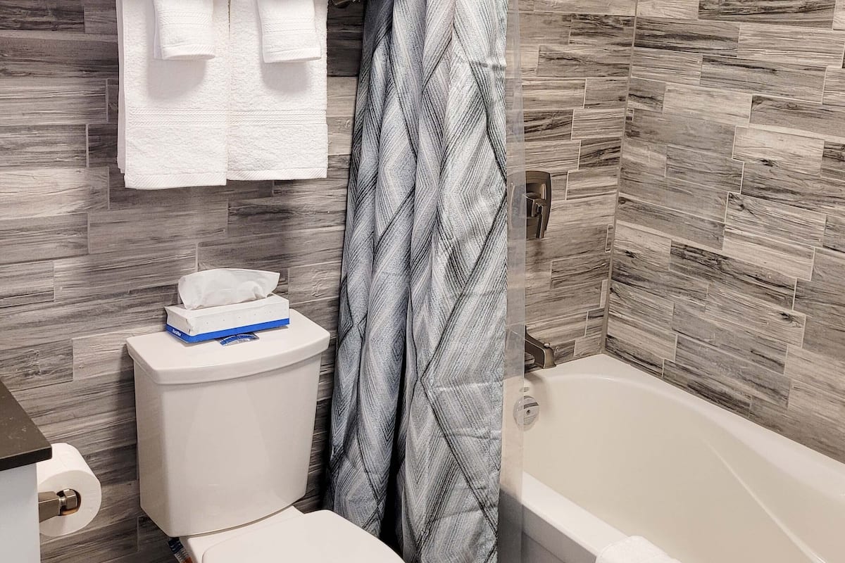 double queen | bathroom | rainfall showerhead, free toiletries, hair dryer, towels