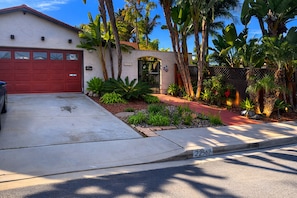 A residential house with a red garage door, a driveway, and a street number 22562.