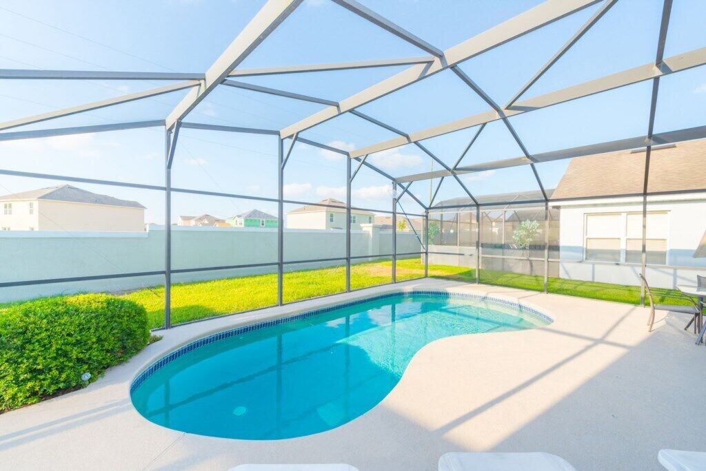 A covered swimming pool with a clear view of the surrounding neighborhood.