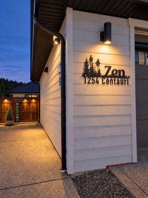 A building with a sign reading 'Zen 1254 Centauri' and a welcome sign. - Zen Mountaire retreat, 1 bedroom, 1 bath, private parking (Langford)