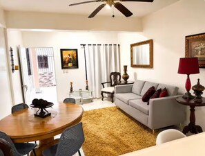 A living room with a dining table, sofa, and a ceiling fan. - Marant's Lodge #2 (Puerto Plata)