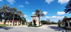 Stunning traditional architecture surrounded by lush greenery and a well-maintained road.